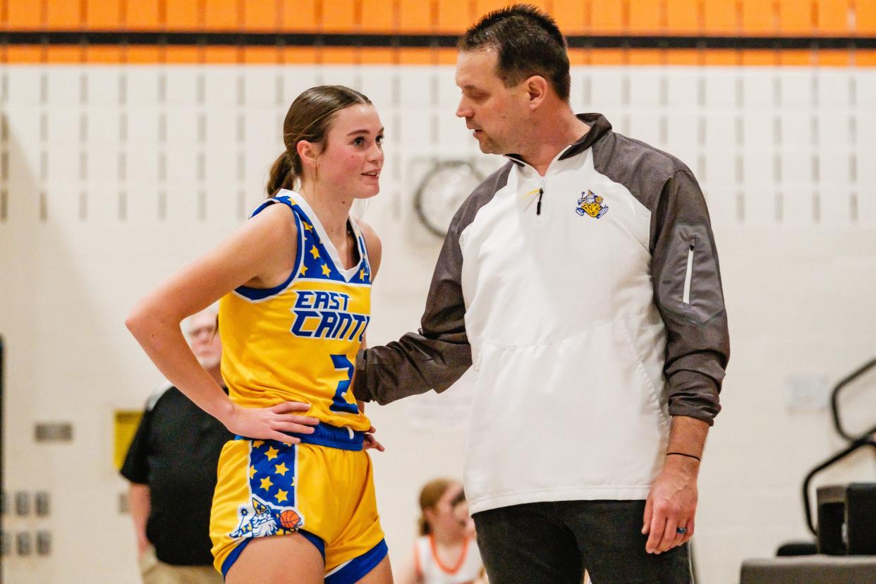 East Canton's Audrey Wade listens to her father, Wizards head coach Jason Wade, during a girls basketball game this season.