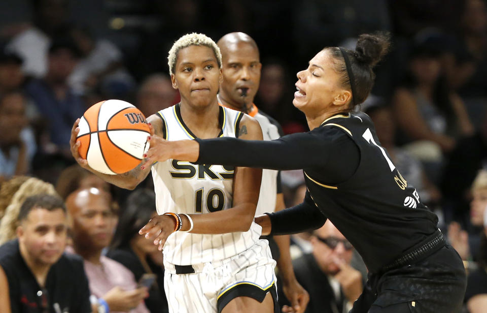 Las Vegas Aces forward Alysha Clark (7) steals the ball from Chicago Sky guard Courtney Williams (10) during the first half of Game 2 of a WNBA basketball playoff series game, Sunday, Sept. 17, 2023, in Las Vegas. (Steve Marcus/Las Vegas Sun via AP)