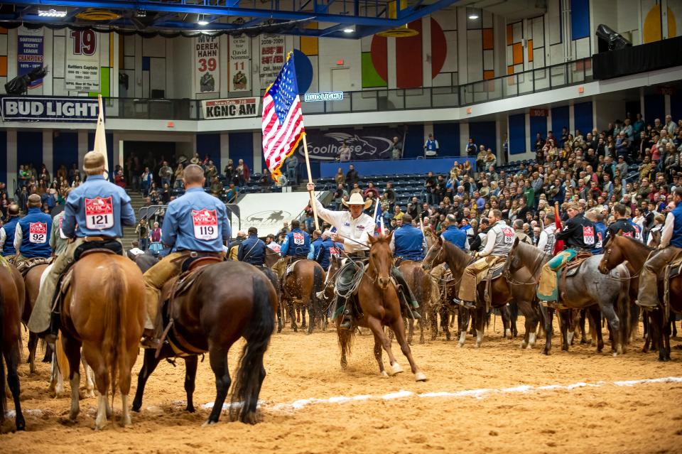 The 2021 Top Hand Justin Pewterson from Haywire Cattle Co. carries the flag during the opening ceremony at 
the 2022 WRCA World Championship Ranch Rodeo at the Amarillo Civic Center in this file photo. This year's event, the 28th annual competition, began Thursday.