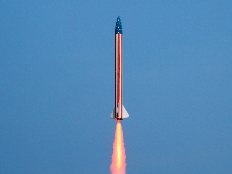 rocket taking off american flag