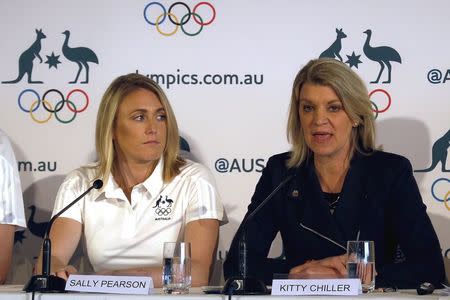 Australia's Olympic 100 metres hurdles champion Sally Pearson (L), who has been ruled out of this month's world championships in Beijing due to injury, listens to Australia's chef de mission Kitty Chiller as she speaks during a media conference in Sydney, Australia, August 5, 2015. REUTERS/David Gray