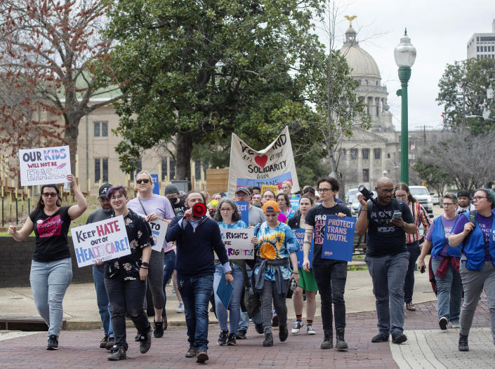 FILE - Marchers voicing objection to House Bill 1125 prohibiting transgender-related healthcare in Mississippi for people under the age of 18, walk from the State Capitol to the governor's mansion following a rally in Jackson, Miss., in support of trans youth on Feb. 15, 2022. Legislation to restrict gender-affirming care is often pre-written and shopped out by a handful of interest groups. Critics say such "model legislation" allows a handful of far-right groups to create a false narrative that is based on distorted science and theology. (Barbara Gauntt/The Clarion-Ledger via AP, File)