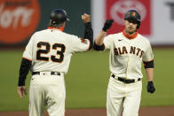 San Francisco Giants' Austin Slater, right, celebrates with third base coach Ron Wotus after hitting a solo home run against the Colorado Rockies during the first inning of a baseball game in San Francisco, Tuesday, Sept. 22, 2020. (AP Photo/Jeff Chiu)