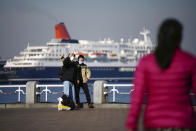 Visitors wearing protective masks take a selfie at a park Thursday, Dec. 16, 2021, in Yokohama, near Tokyo. (AP Photo/Eugene Hoshiko)