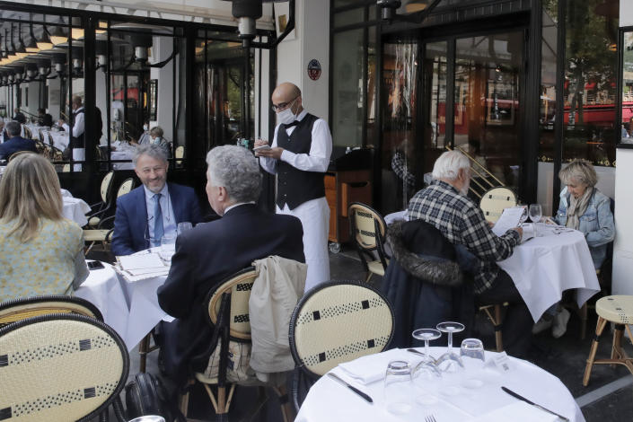 A waiter takes the order at La Coupole restaurant, Monday, June 15, 2020 in Paris. (Christophe Ena/AP)