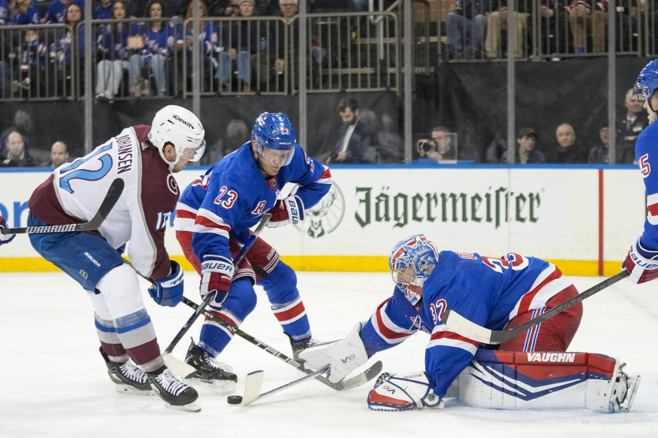 New York Rangers goaltender Jonathan Quick (32) and defenseman Adam Fox (23) tend the net against Colorado Avalanche center Ryan Johansen (12) during the first period of an NHL hockey game, Monday, Feb. 5, 2024, at Madison Square Garden in New York. (AP Photo/Mary Altaffer)