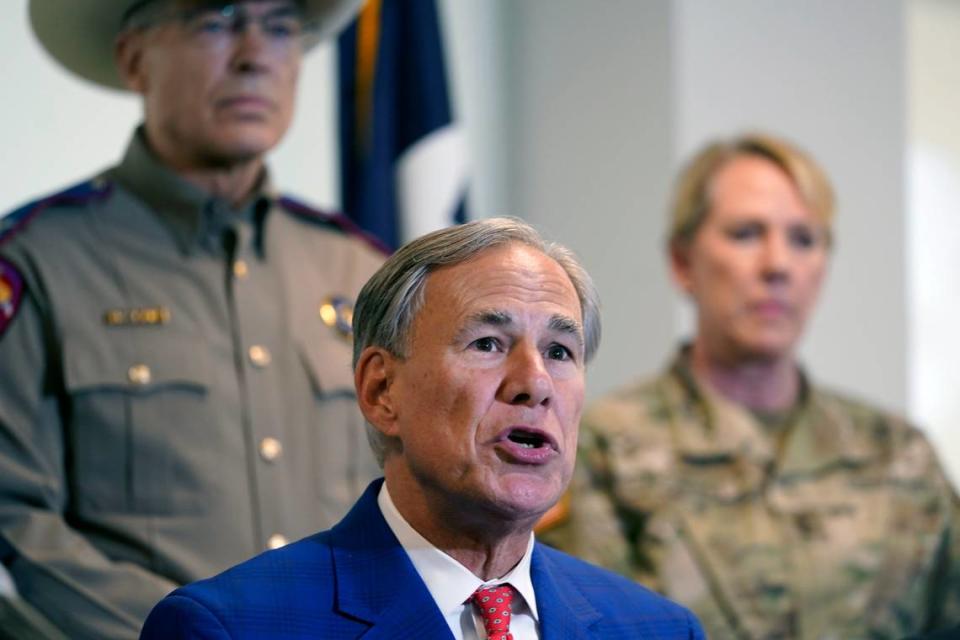 Gov. Greg Abbott speaks with Texas Department of Public Safety Director Steven McCraw and Texas National Guard Director Maj. Gen. Tracy Norris behind him Friday in Fort Worth. Abbott signed a bill providing $2 billion for border security and drug enforcement.