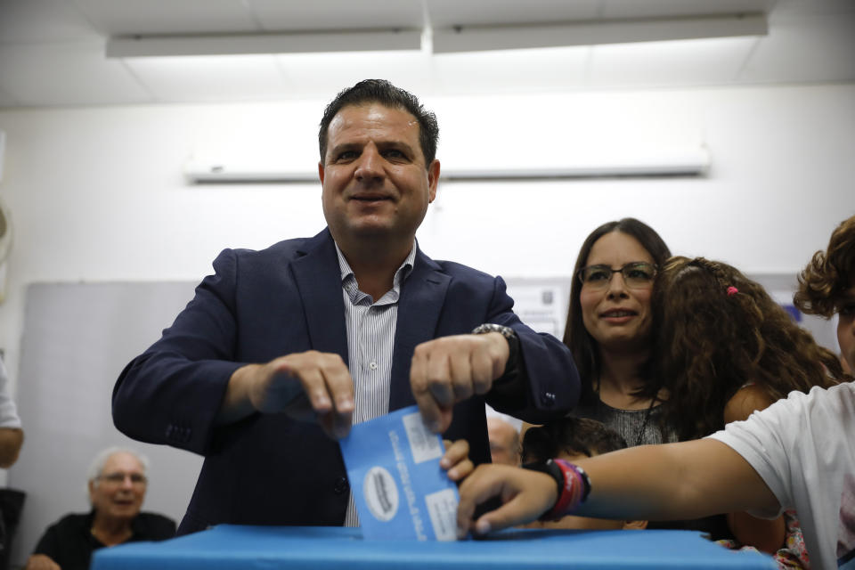 FILE - In this Tuesday, Sept. 17, 2019. file photo, Israeli Arab politician Ayman Odeh casts his vote in Haifa, Israel. Israel’s Arab coalition appears poised to emerge as the main opposition bloc following Tuesday’s vote. The historic first would grant a new platform to a long-marginalized minority and the only major political movement still pushing for peace with the Palestinians. (AP Photo/Ariel Schalit, File)