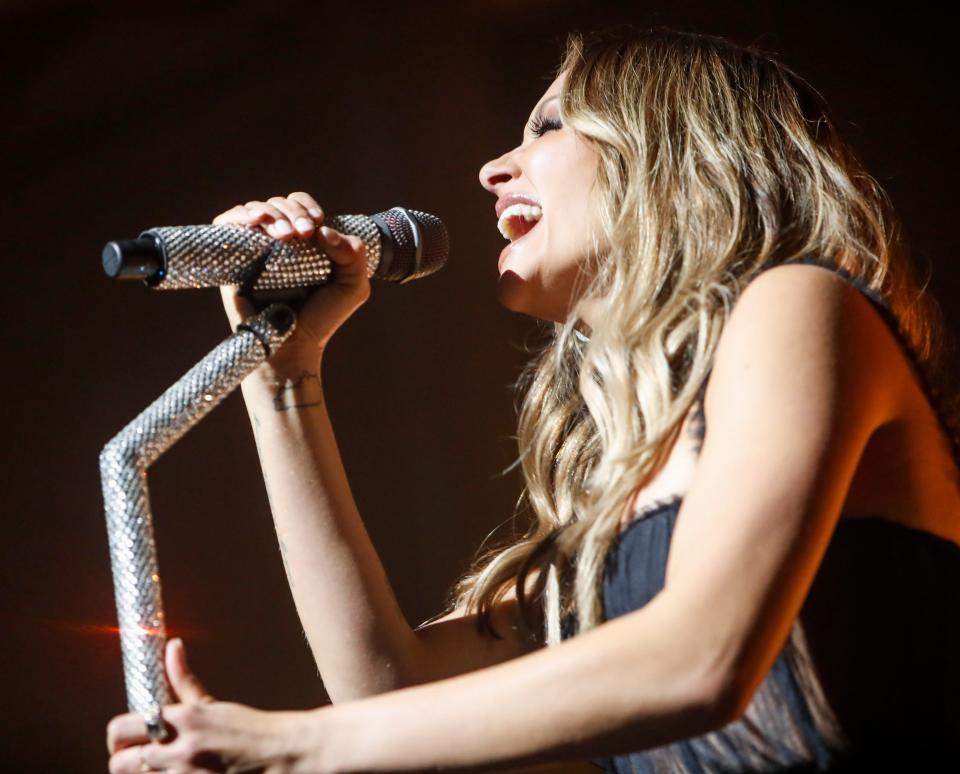 Carly Pearce sings into the mic during Pearce's Nashville stop on her "The 29 Tour" at the CMA Theater in Nashville, Tenn., on Thursday, Dec. 2, 2021. 