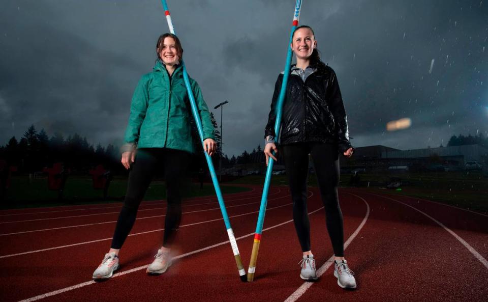 Capital High twin sisters Hana Moll (left) and Amanda Moll are leading the nation in high school girls pole vault, including Amanda’s national record vault of 14’ 9 1/2”. They are shown during a stormy practice at Capital High School in Olympia, Washington, on Monday, April 18, 2022.