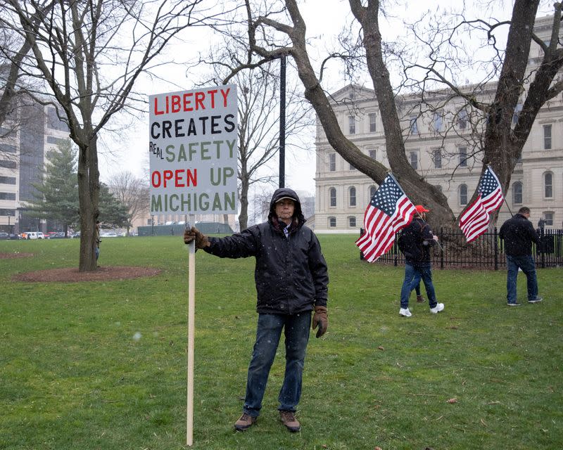 Protesters against the state's extended stay-at-home order demonstrate in Lansing