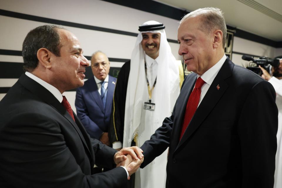 DOHA, QATAR - NOVEMBER 20: Turkish President Recep Tayyip Erdogan shakes hands with President of Egypt Abdel Fattah el-Sisi as they attend a reception hosted by Qatari Emir Sheikh Tamim bin Hamad Al Thani on the occasion of the opening ceremony of the 2022 FIFA World Cup in Qatar on November 20, 2022. (Photo by Murat Kula/Anadolu Agency via Getty Images)