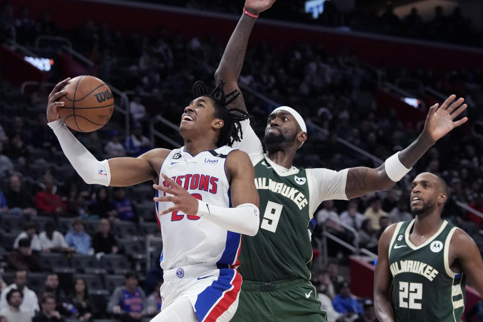 Detroit Pistons guard Jaden Ivey (23) attempts a layup as Milwaukee Bucks forward Bobby Portis (9) defends during the second half of an NBA basketball game, Monday, March 27, 2023, in Detroit. (AP Photo/Carlos Osorio)