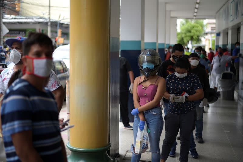 People wait in line to buy supplies amid the spread of the coronavirus disease (COVID-19), in Guayaquil