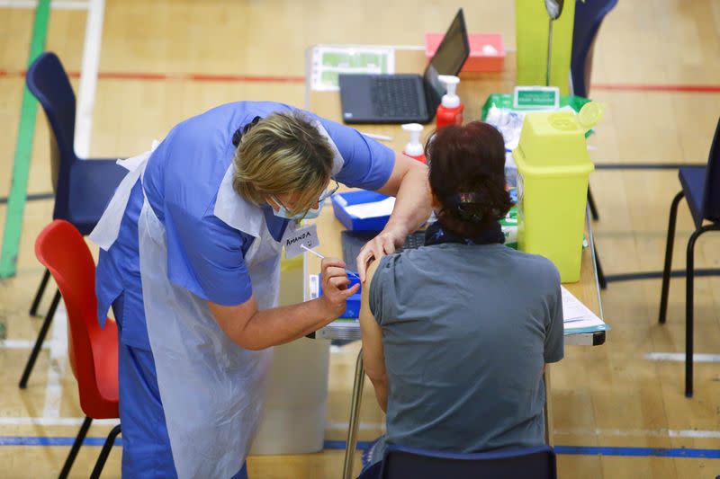 FILE PHOTO: Britain's Prime Minister Boris Johnson visits a vaccination centre at Cwmbran Stadium