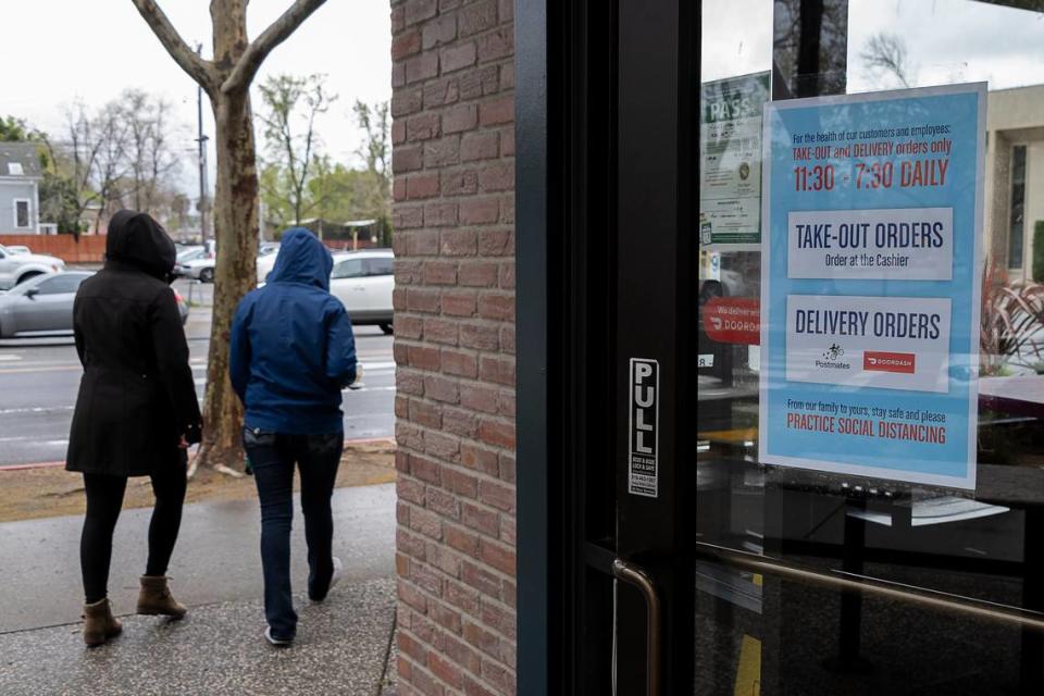 Customers pick up take-out food from Jacks Urban Eats on Monday, March 16, 2020 in midtown Sacramento. Jacks has switched to take-out orders only at all of its locations in the Sacramento area as a response to the state and local government recommendations to stop the spread of the coronavirus. There is no dine-in service available.