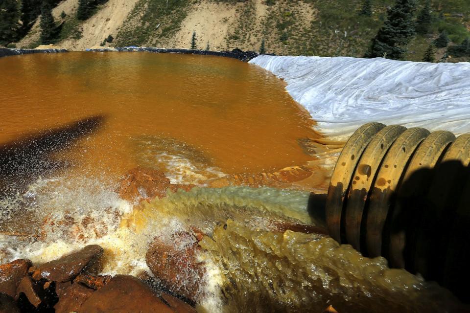 Water from a 2015 spill at the abandoned Gold King mine in southwest Colorado flows into a holding pond. The spill released 3 million gallons of water laced with toxic metals, contaminating rivers in three states and the Navajo Nation. <a href="https://newsroom.ap.org/detail/NewMexicoMineSpillSettlementGrants/f4d3c34b13894facae77fc6ef413c45a/photo" rel="nofollow noopener" target="_blank" data-ylk="slk:AP Photo/Brennan Linsley;elm:context_link;itc:0;sec:content-canvas" class="link ">AP Photo/Brennan Linsley</a>