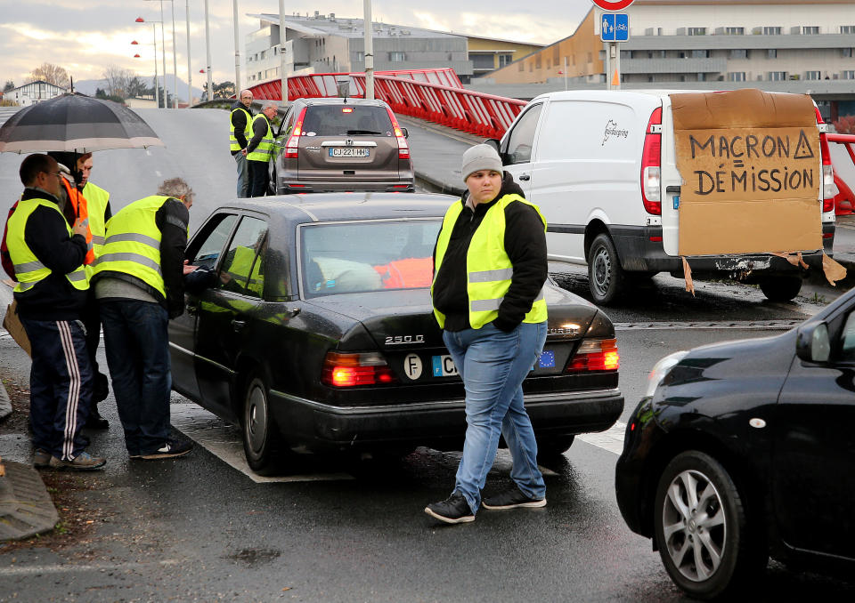 Demonstrators block cars in Bayonne, southwestern France, Sunday, Nov. 18, 2018. One protester was killed and 227 other people were injured — eight seriously — at roadblocks set up around villages, towns and cities across France on Saturday as citizens angry with rising fuel taxes rose up in a grassroots movement, posing a new challenge to beleaguered President Emmanuel Macron. (AP Photo/Bob Edme)