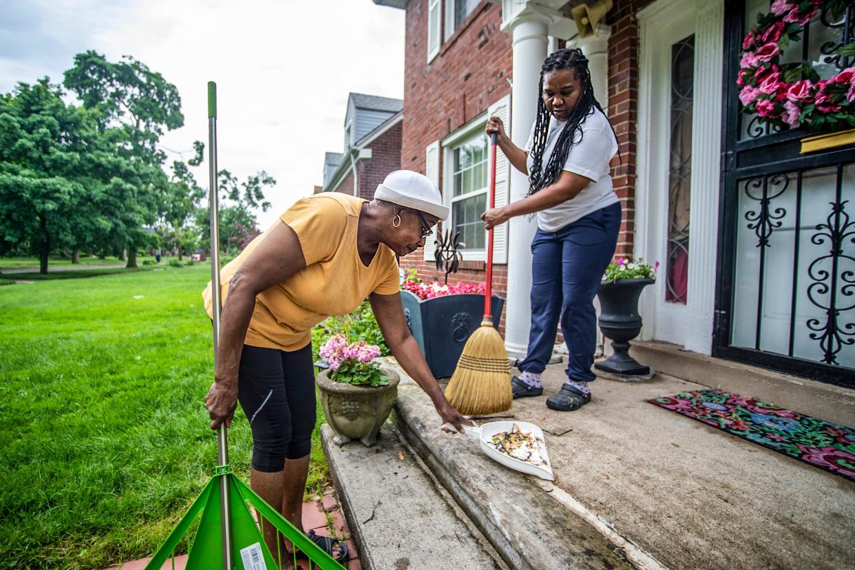 Dorothy Osborne, 76, and Vivian Kidd, 56, clean up after a flash storm around the Grandmont neighborhood in Detroit on Wednesday, June 1, 2022. 