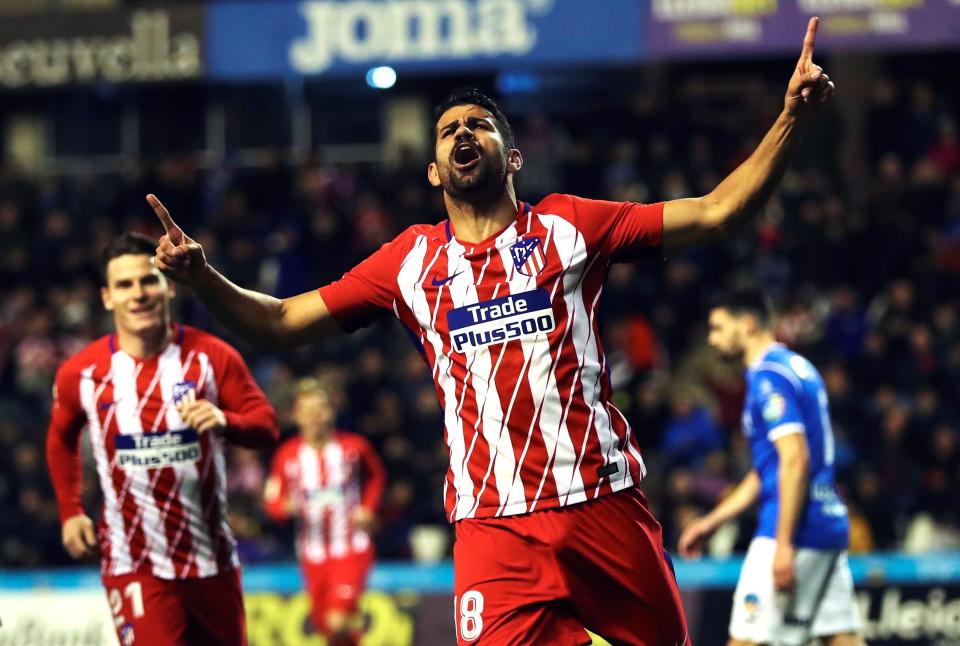 Diego Costa (18) celebrates after scoring five minutes into his Atletico Madrid return. (EFE)
