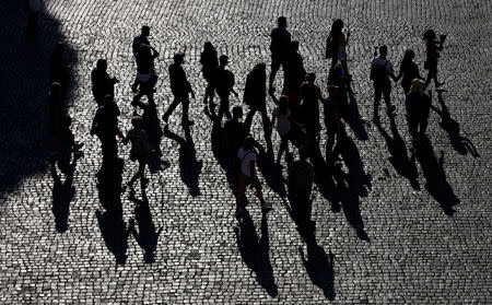 Tourists walk outside the Colosseum in Rome, Italy, October 17, 2017. Picture taken October 17, 2017. REUTERS/Max Rossi