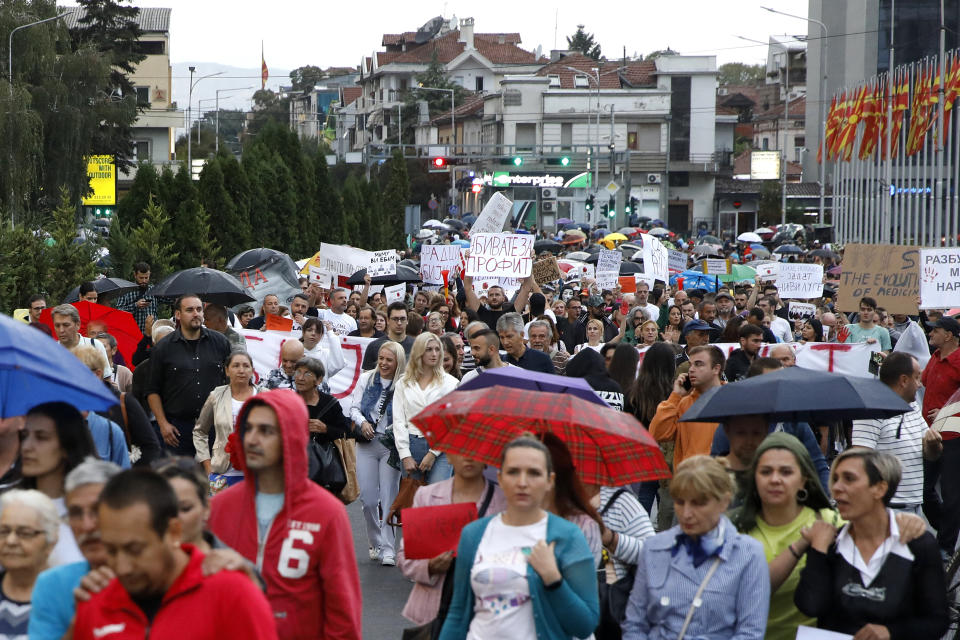 People protest, marching in front of the Government building in Skopje, North Macedonia, on Monday, Sept. 4. 2023. Thousands have gathered late on Monday in front of the government in North Macedonia's capital Skopje to protest on scandal that broke after media reported that employees in the state running Clinic of Oncology allegedly were selling on a black market a million of dollars' worth clinic supply of drugs needed for cancer treatment. (AP Photo/Boris Grdanoski)