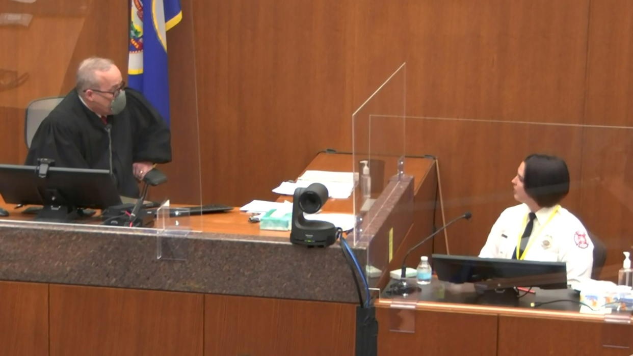 Hennepin County District Judge Peter Cahill speaks to witness Genevieve Hansen, a fire department emergency medical technician (EMT) on the second day of the trial of former Minneapolis police officer Derek Chauvin for second-degree murder, third-degree murder and second-degree manslaughter in the death of George Floyd in Minneapolis, Minnesota, U.S. March 30, 2021 in a still image from video.  Pool via REUTERS