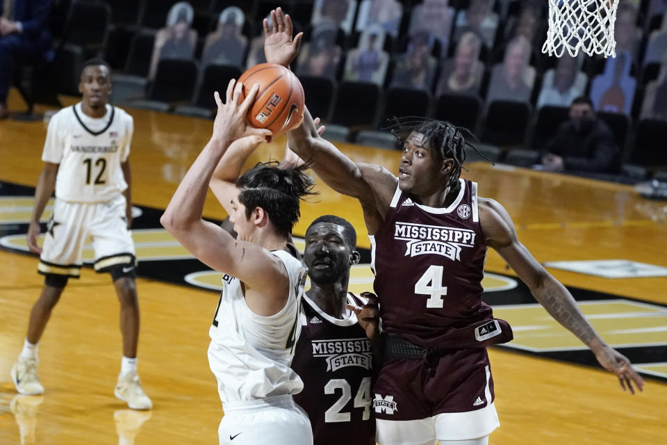 Mississippi State guard Cameron Matthews (4) tries to knock the ball away from Vanderbilt forward Quentin Millora-Brown (42) in the first half of an NCAA college basketball game Saturday, Jan. 9, 2021, in Nashville, Tenn. (AP Photo/Mark Humphrey)