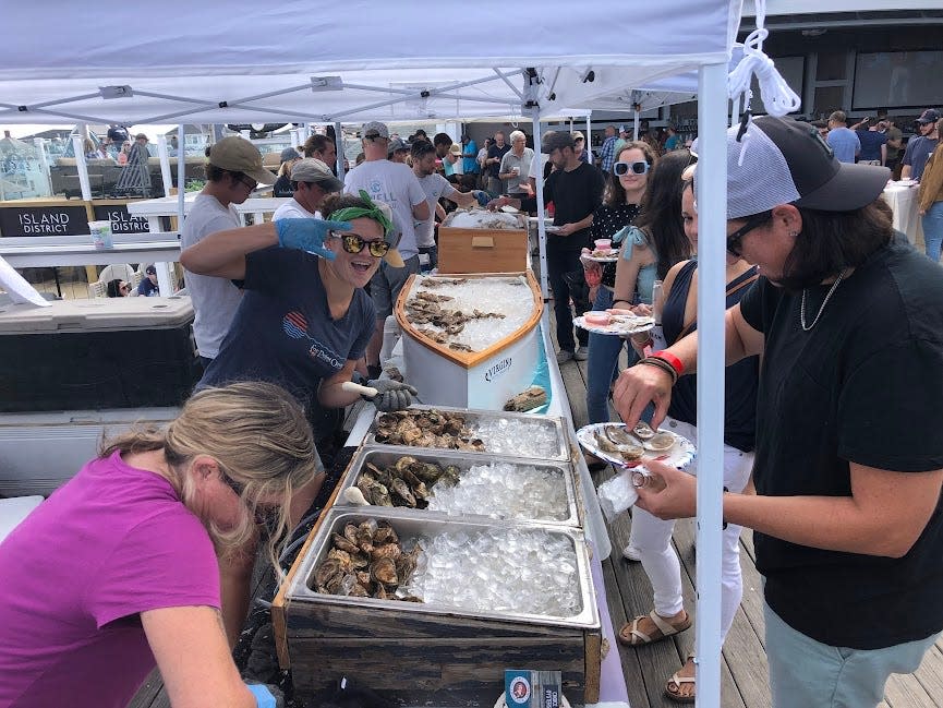 A shucker from Fox Point Oysters gets into the spirit at last year's Oysterfest at Bernie's Beach Bar. Oyster Week returns to the Seacoast and Bernie's Sept. 18-24.