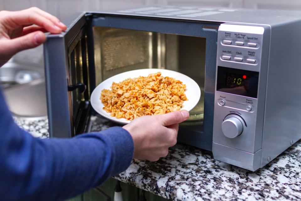When reheating rice in a microwave, make sure the internal temperature of the rice reaches at least 165 degrees Fahrenheit. Getty Images