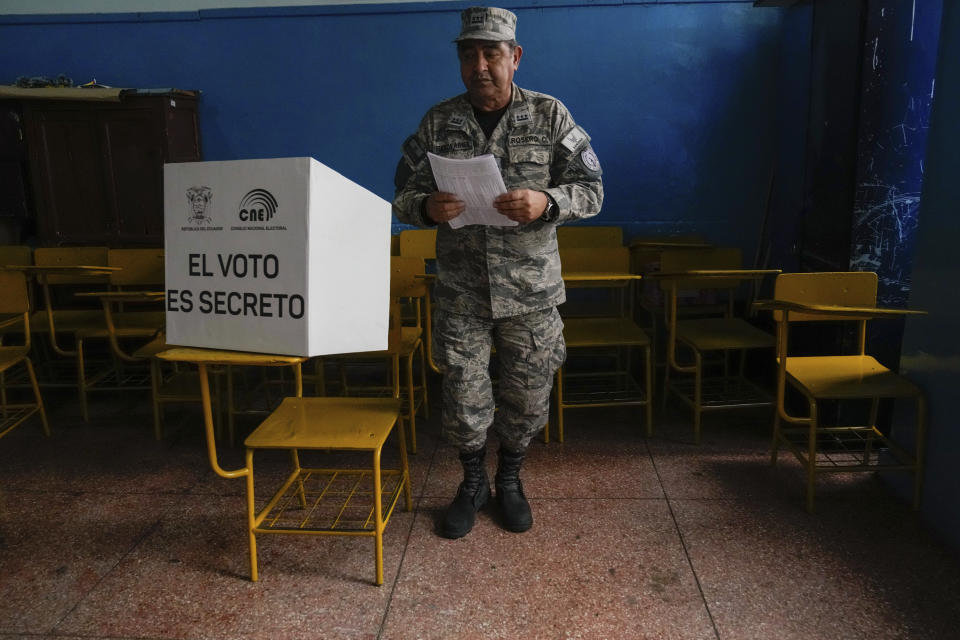 An Air Force officer votes in a referendum proposed by President Daniel Noboa to endorse new security measures aimed at cracking down on criminal gangs fueling escalating violence, in Quito, Ecuador, Sunday, April 21, 2024. (AP Photo/Dolores Ochoa)