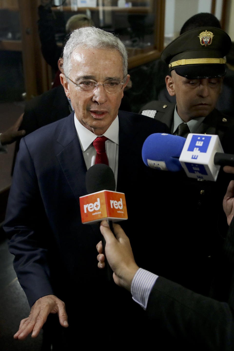Senator and former president Alvaro Uribe arrives to the Supreme Court for questioning in an investigation for witness tampering charges in Bogota, Colombia, Tuesday, Oct. 8, 2019. Uribe is under investigation over allegations he made false accusations and tried to influence members of a former paramilitary group in a case he started by making similar accusations against leftist Senator Ivan Cepeda. (AP Photo/Ivan Valencia)