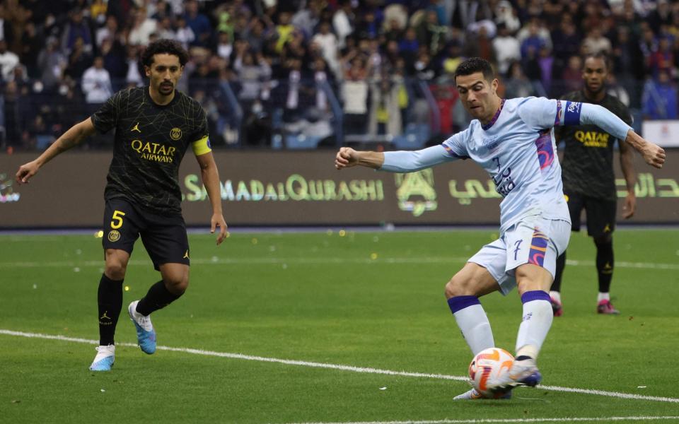 Riyadh All-Star's Portuguese forward Cristiano Ronaldo shoots to score his second goal during the Riyadh Season - AFP