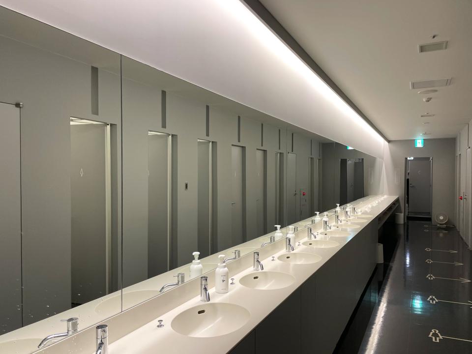 A row of sinks in the capsule hotel.