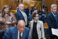 Protesters hold up signs saying "Stop Denying Us Care" as Andrew Witty, Chief Executive Officer of UnitedHealth Group, front, gathers his papers after testifying at a Senate Finance Committee hearing examining cyber attacks on health care, and the Change Healthcare cyber attack, Wednesday, May 1, 2024, on Capitol Hill in Washington. The people were protesting claim denials and prior authorization requests that they say delays care. (AP Photo/Jacquelyn Martin)