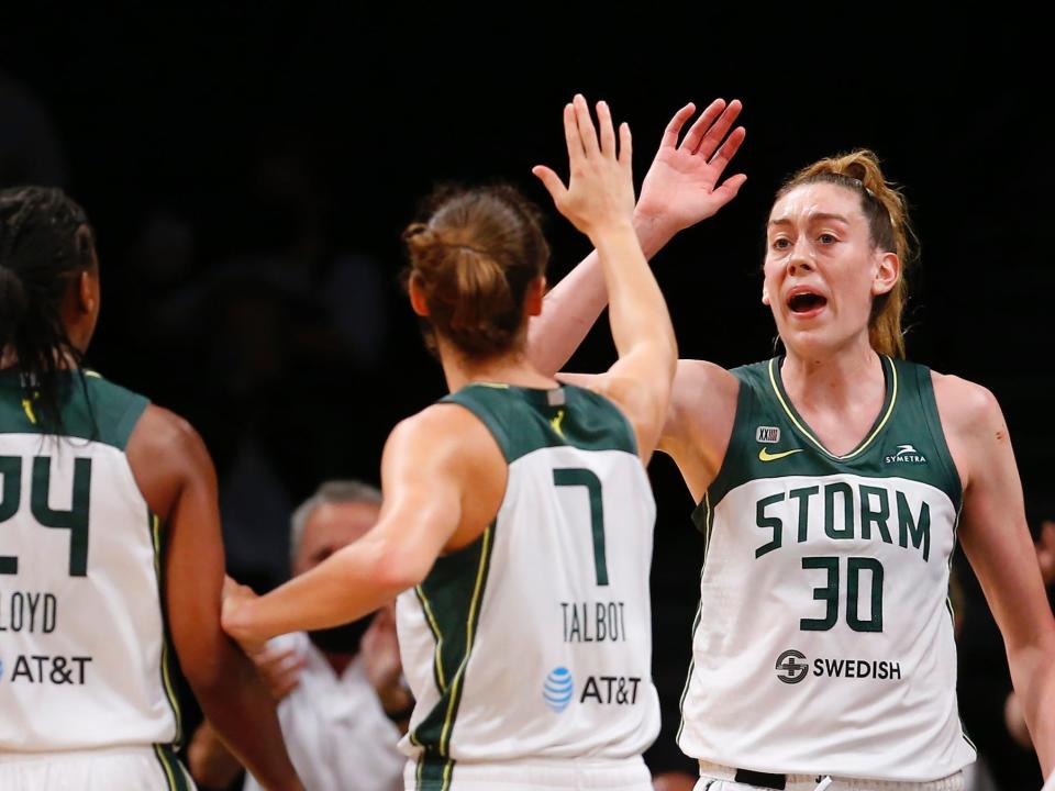 Stephanie Talbot high-fives Seattle Storm teammate Breanna Stewart.