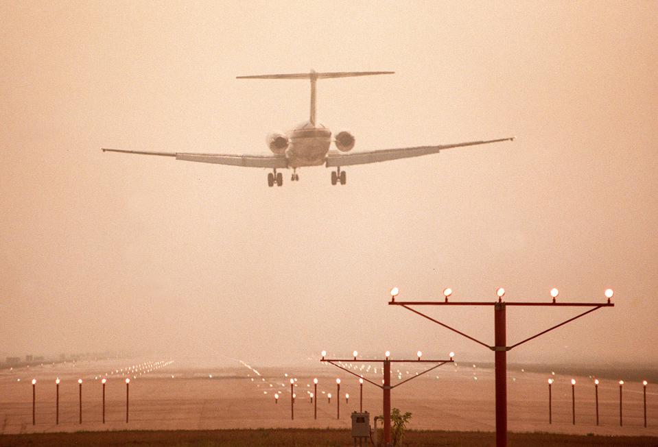 A Delta Airlines flight lands at Daytona International Airport in heavy smoke caused by wildfires on June 22, 1998. Longtime residents who endured six weeks of devastating wildfires that burned more than 234,000 acres in Volusia and Flagler counties know to take precautions to prevent them seriously.