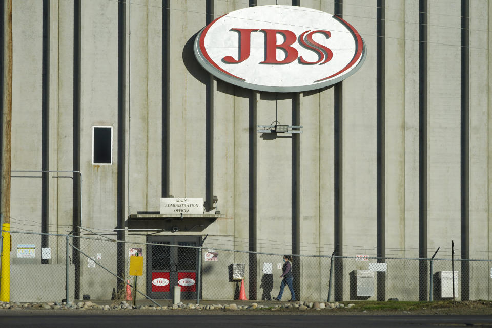 A worker heads into the JBS meatpacking plant Monday, Oct. 12, 2020, in Greeley, Colo. (AP Photo/David Zalubowski)