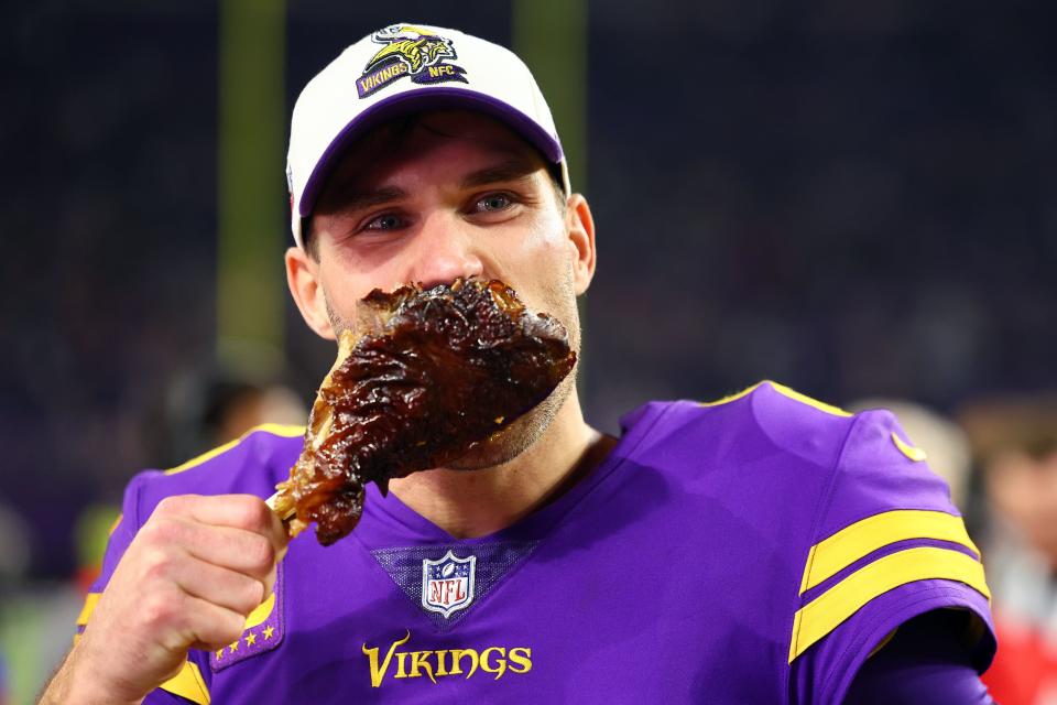 MINNEAPOLIS, MINNESOTA - NOVEMBER 24: Kirk Cousins #8 of the Minnesota Vikings eats a turkey leg on the field after defeating the New England Patriots at U.S. Bank Stadium on November 24, 2022 in Minneapolis, Minnesota. (Photo by Adam Bettcher/Getty Images)