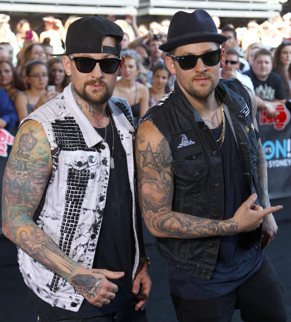 American rocker brothers Joel, right, and Benji Madden pose for photographers upon arrival for the Australian music industry Aria Awards in Sydney, Thursday, Nov. 29, 2012. (AP Photo/Rick Rycroft)