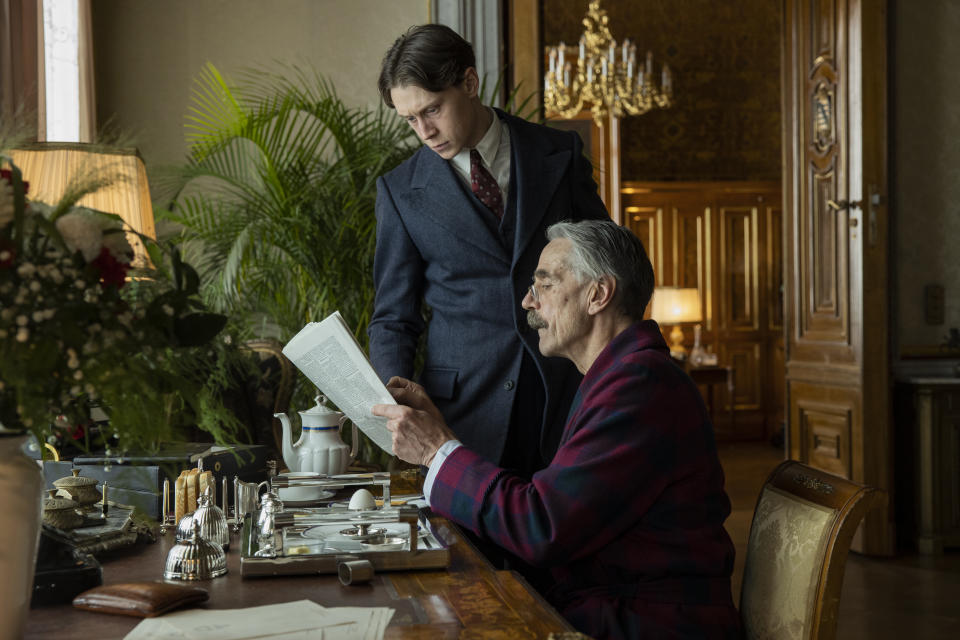 This image released by Netflix shows George MacKay as Hugh Legat, and Jeremy Irons as Neville Chamberlain in a scene from "Munich: The Edge of War." (Frederic Batier/Netflix via AP)