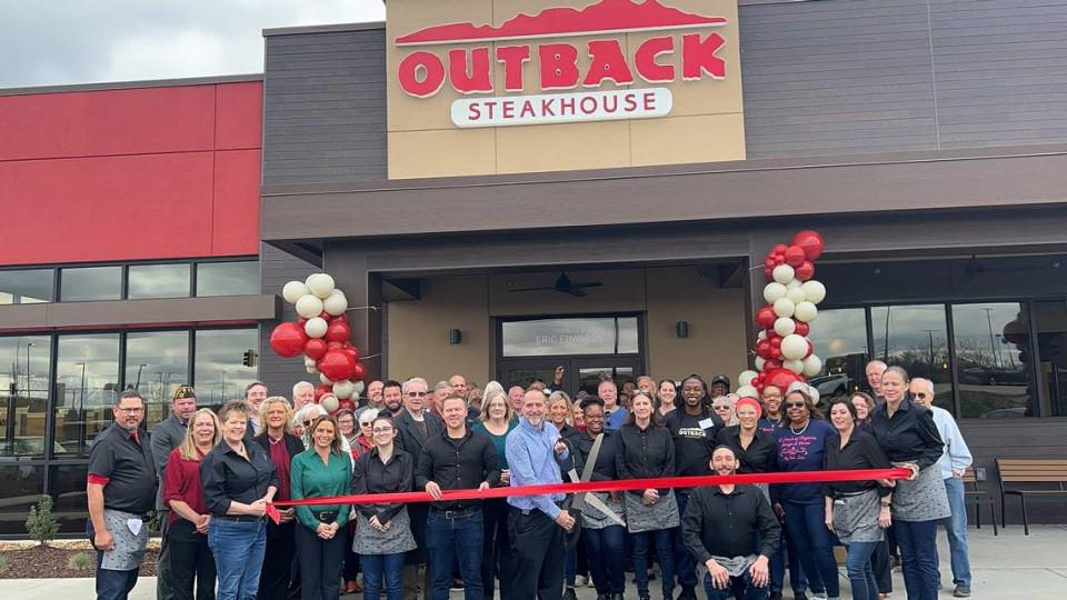 Outback Steakhouse in O’Fallon celebrated a ribbon-cutting on Thursday, April 4. Holding the scissors is Eric Edwards, proprietor of the new location.