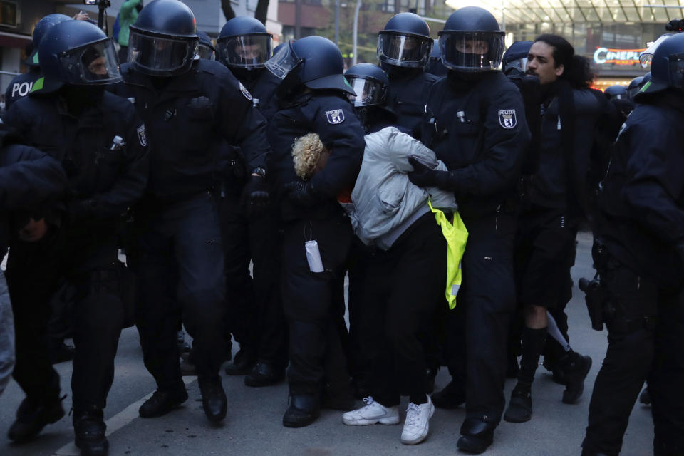 Police officers detain a demonstrator during a May Day rally in Berlin, Germany, Saturday, May 1, 2021. (AP Photo/Markus Schreiber)