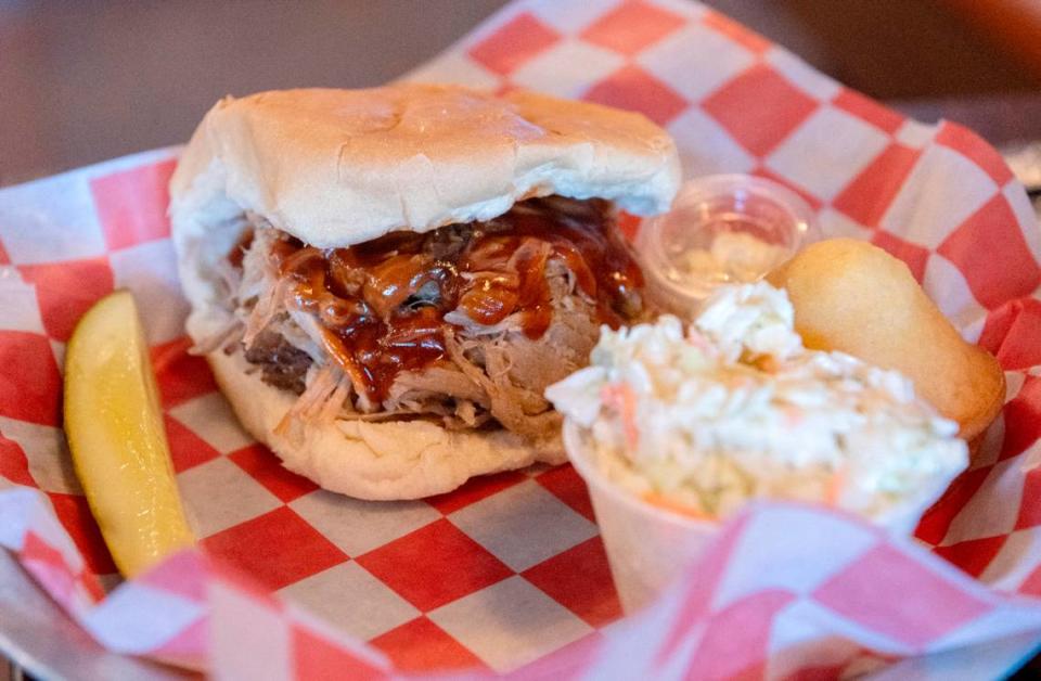 A pulled pork sandwich with coleslaw and a cornbread muffin is pictured at Prospector’s on Thursday, June 1, 2023.