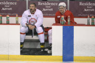 Washington Capitals left wing Alex Ovechkin, left, and defenseman Dmitry Orlov (9) watch during a drill at practice at the team's NHL hockey training camp, Thursday, Sept. 23, 2021, in Arlington, Va. (AP Photo/Nick Wass)