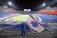 Buffalo Bills fans leave Bills Stadium as a mascot waves a flag after an NFL divisional round football game against the Baltimore Ravens Saturday, Jan. 16, 2021, in Orchard Park, N.Y. The Bills won 17-3. (AP Photo/Adrian Kraus)