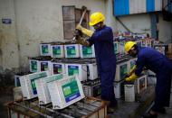 Workers dismantle batteries to obtain lead from them at ACE Green recycling Inc in Ghaziabad