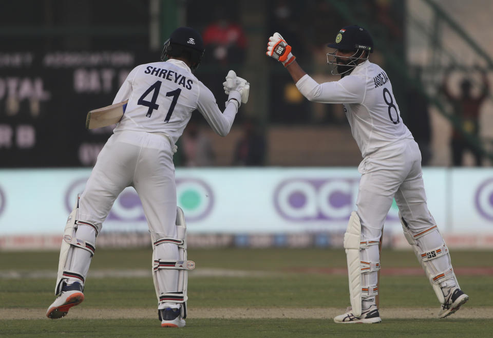 India's Shreyas Iyer, left, congratulates his teammate Ravindra Jadeja, right, after he scored 50 runs during the day one of their first test cricket match with New Zealand in Kanpur, India, Thursday, Nov. 25, 2021. (AP Photo/Altaf Qadri)