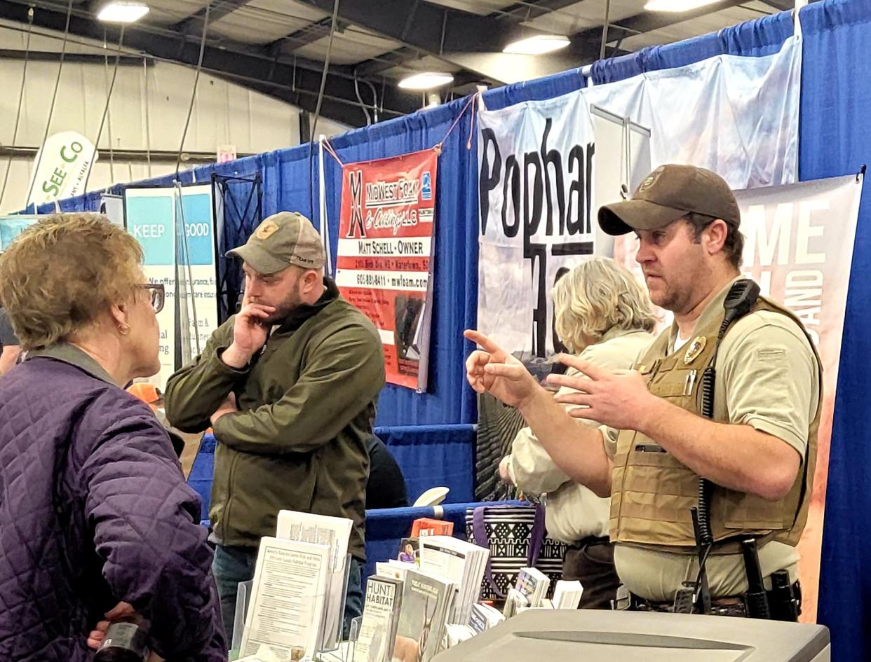 Wildlife Conservation Officer Adam Behnke discusses the many different programs supported by the South Dakota Game, Fish and Parks Department during the Watertown Winter Farm Show Wednesday.