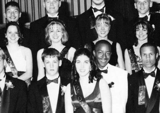 <p>Joel Madden, front left, wasn’t always a tattooed rocker. This 1997 photo from his prom at La Plata High School in La Plata, Md., shows him wearing a suit while being honored as a member of his school’s prom court. Still, don’t be fooled, because he and twin brother, Benji, had already formed their famous band, Good Charlotte. (Photo: Seth Poppel/Yearbook Library) </p>